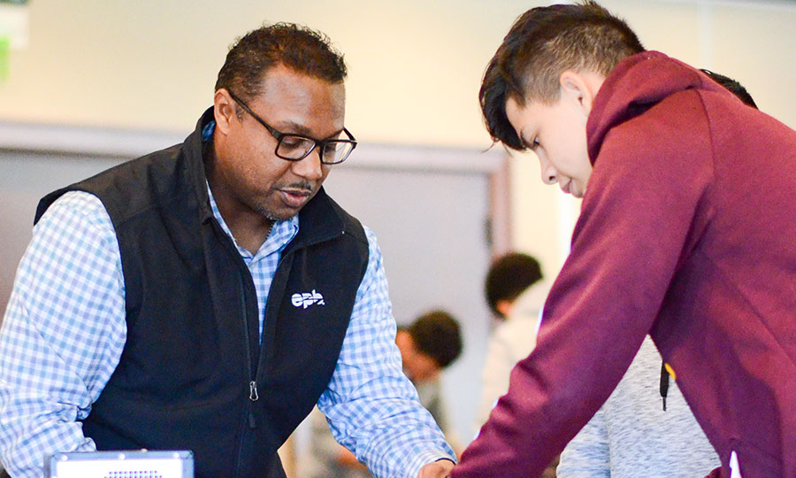 EPB Employee helping student with a computer build