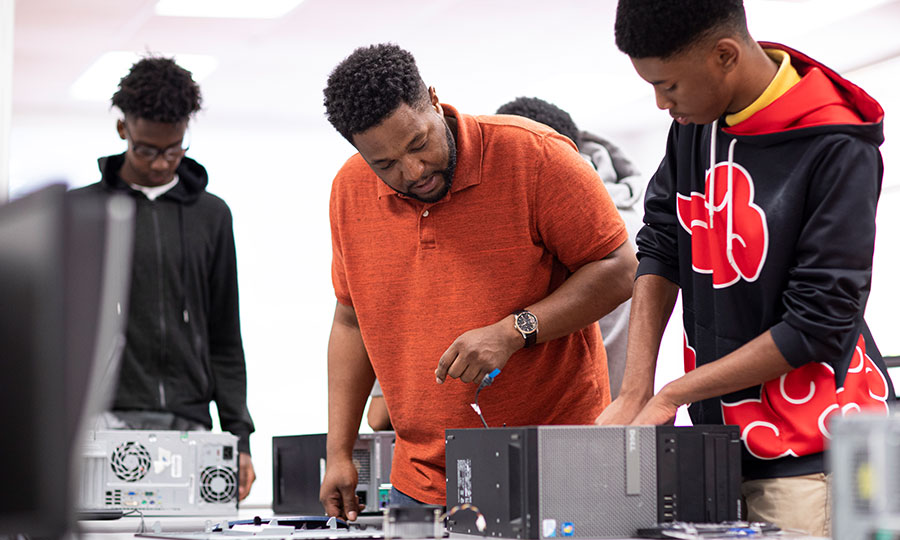 EPB Employee teaching students how to assemble a computer