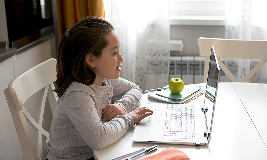 Female student learning remotely on laptop