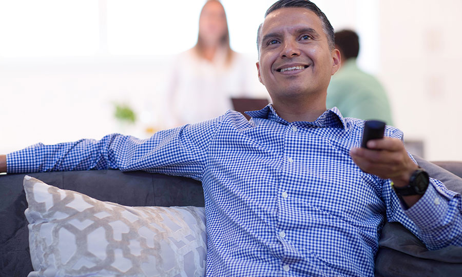 Man smiling with TV Remote