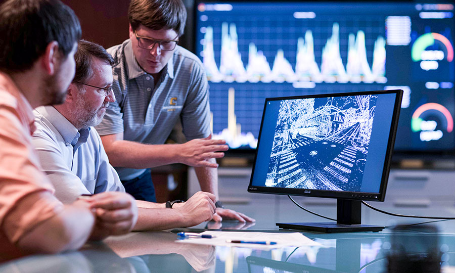 Employees analyzing data on a computer screen