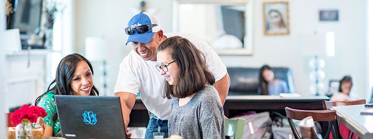 EPB Employee helping two women on a laptop