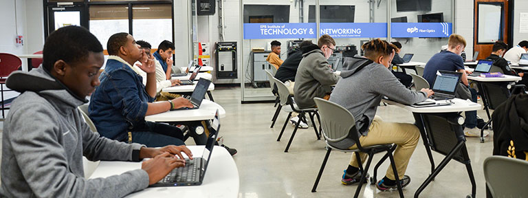 Students working on laptops in the classroom