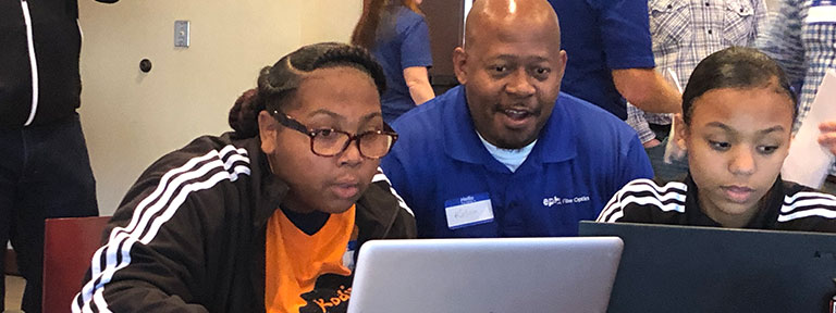 EPB Employee helping students on laptop