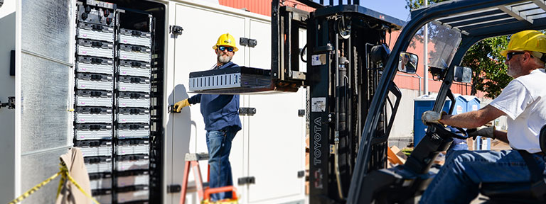 EPB Installers forklifting a large battery