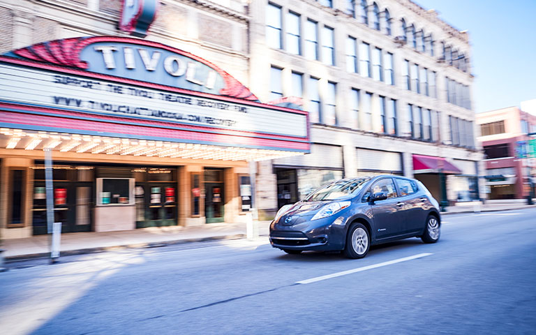 Electric vehicle driving by Tivoli theater
