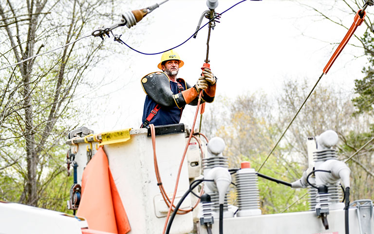 EPB lineman working on power lines in a bucket truck