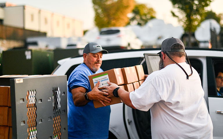 EPB employees handing out energy efficient light bulbs