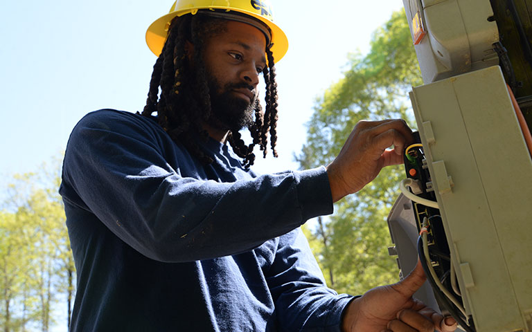 EPB Employee in hardhat working on a panel