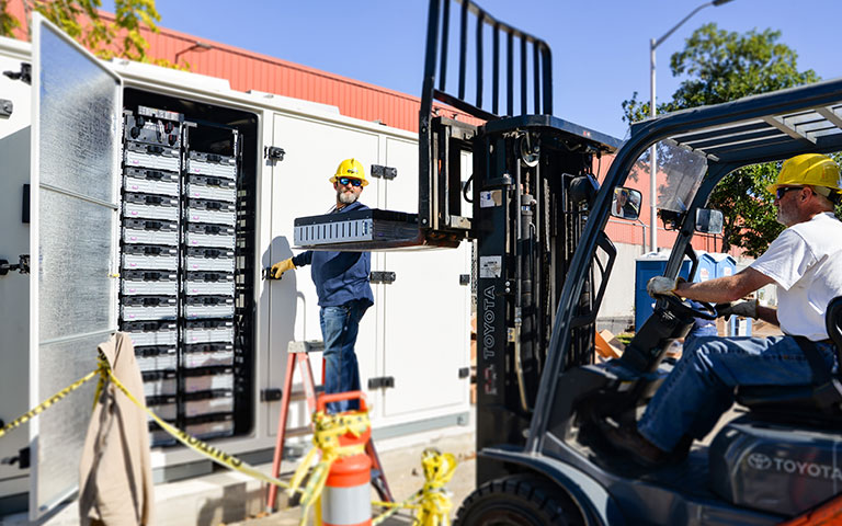 EPB employees using a forklift to install equipment