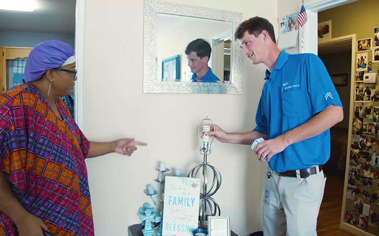 EPB employee helping customer change a light bulb