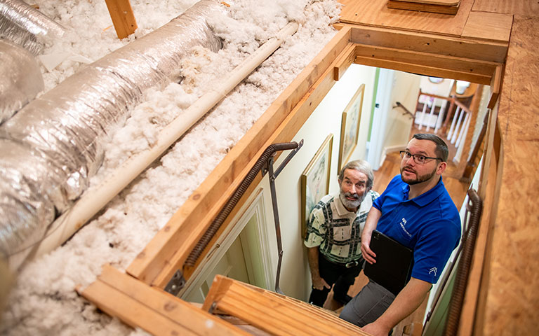 EPB Energy Pro looking into an attic with a homeowner