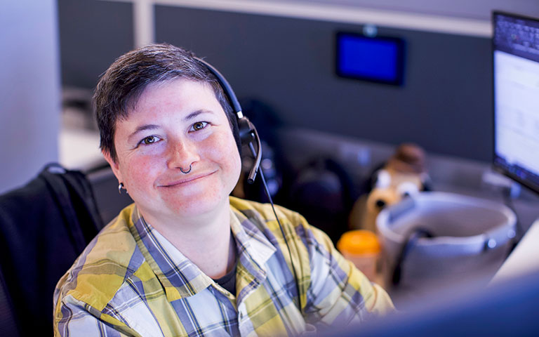 EPB Customer Service Rep smiling at their desk