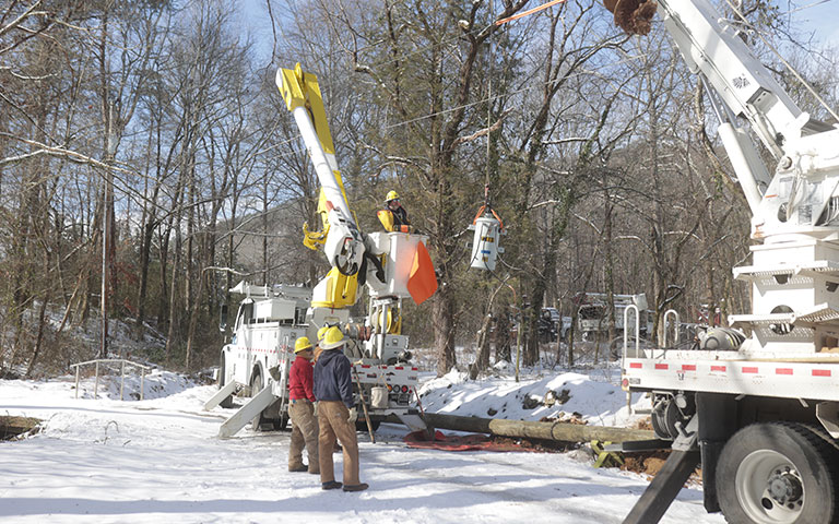 EPB bucket trucks working on lines in the snow