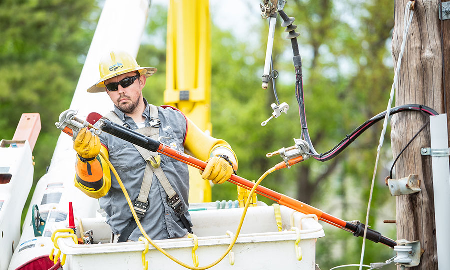 EPB Lineman working on power lines in a bucket truck