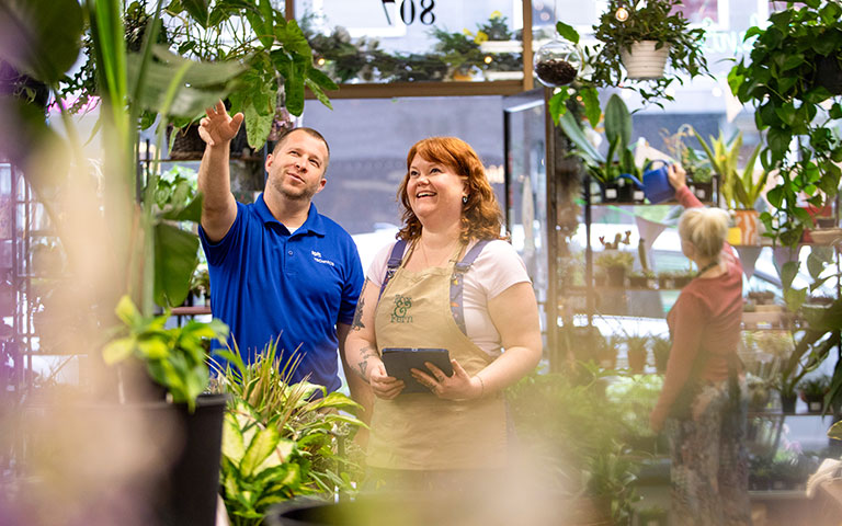 EPB TechPros member helping an EPB Business customer in a greenhouse